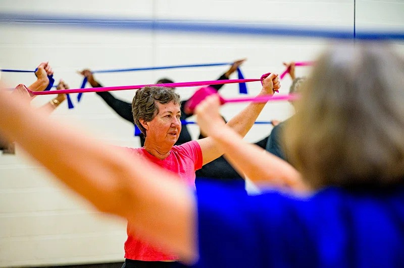 Resistance bands exercise for seniors promoting strength, flexibility, and safe fitness at home or in group classes.