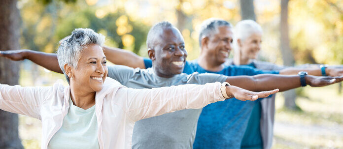 Seniors doing yoga exercises to improve flexibility, balance, and relaxation for healthy aging and active living